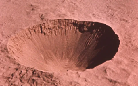 Historical aerial photograph of the large Sedan Crater at the Nevada Test Site.