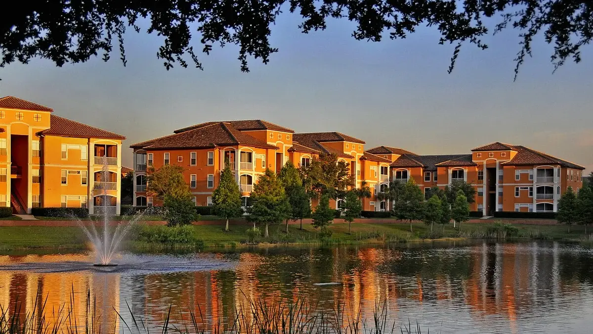 Apartment buildings at the La Palazza complex in MetroWest, Orlando, Florida, reflected in a pond at sunset.