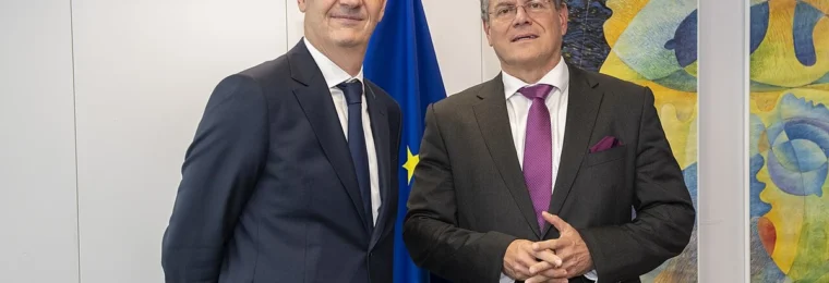 Roland Lescure, at left, and Maroš Šefčovič standing near a European Union flag in Brussels.