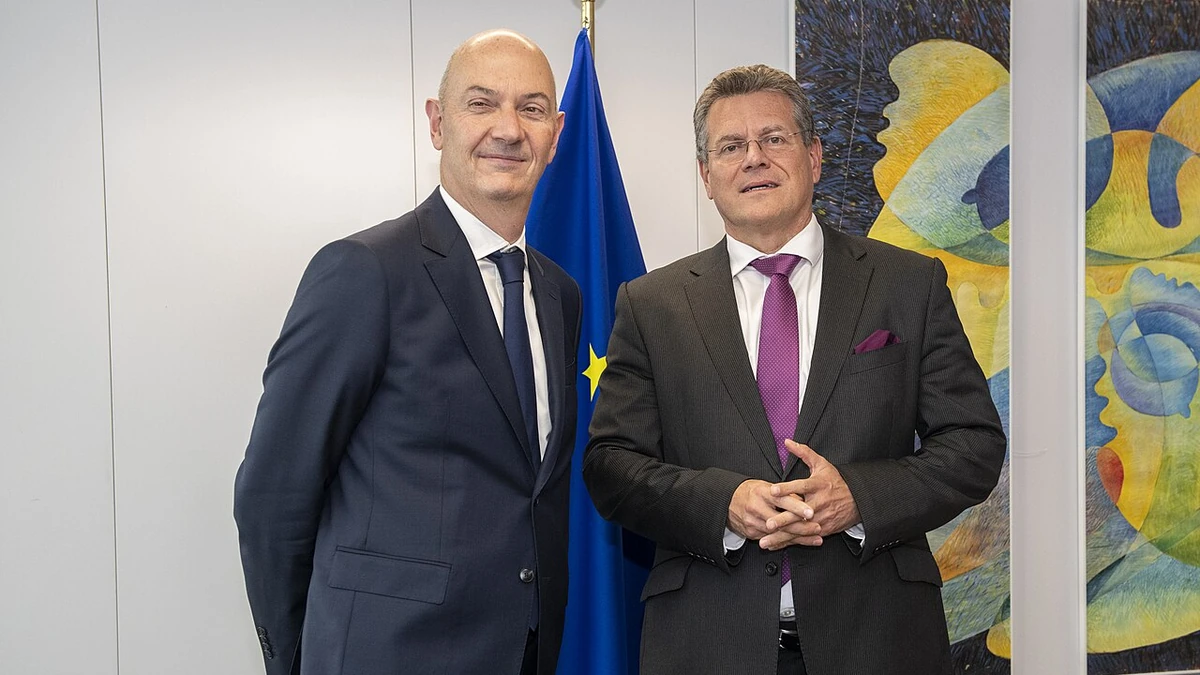 Roland Lescure, at left, and Maroš Šefčovič standing near a European Union flag in Brussels.