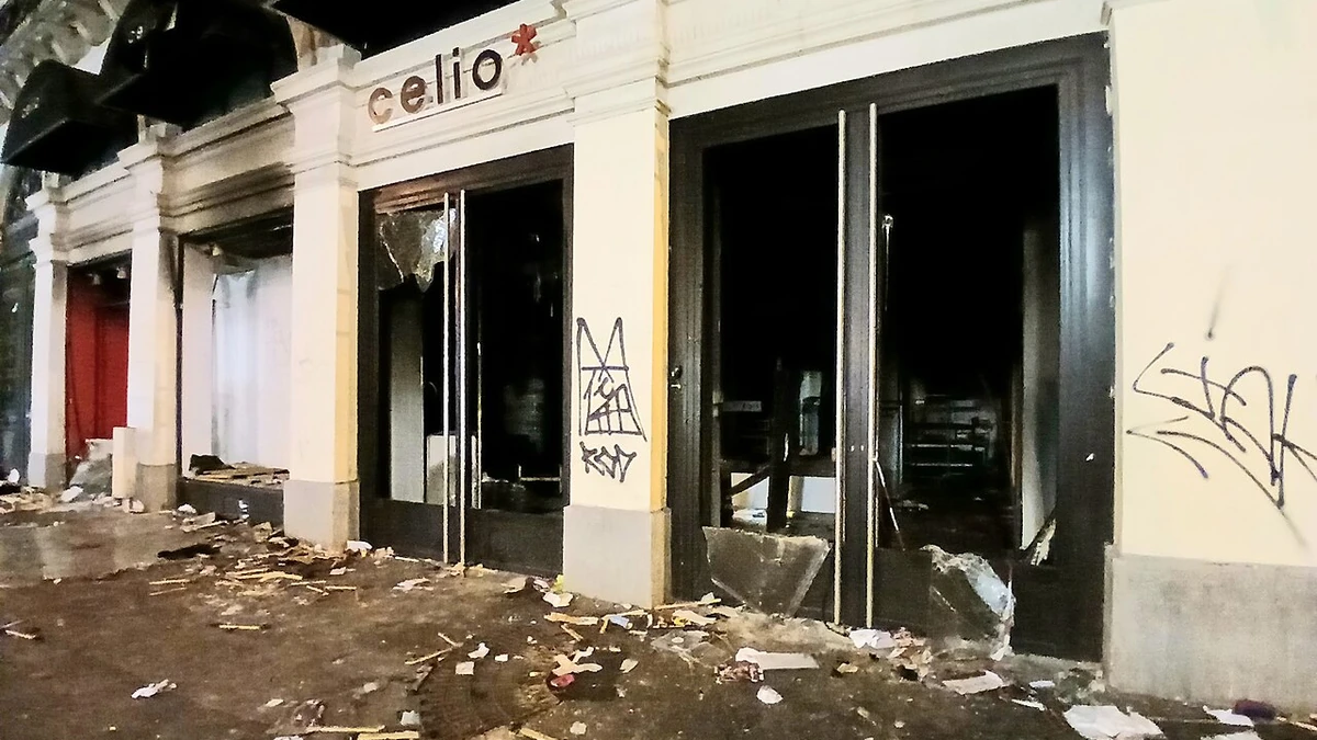 Broken glass, debris and graffiti outside a damaged Célio clothing store near Porte Saint-Denis in Paris.