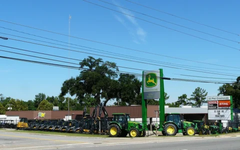 Agricultural equipment displayed outside an Ag-Pro John Deere dealership in Tallahassee, Florida.