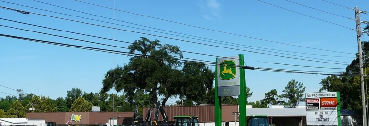 Agricultural equipment displayed outside an Ag-Pro John Deere dealership in Tallahassee, Florida.