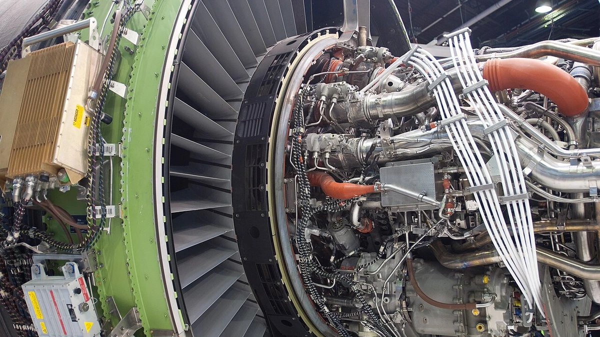 Close-up of a GE GEnx aircraft engine with visible fan blades and exposed piping at the 2011 Paris Air Show.