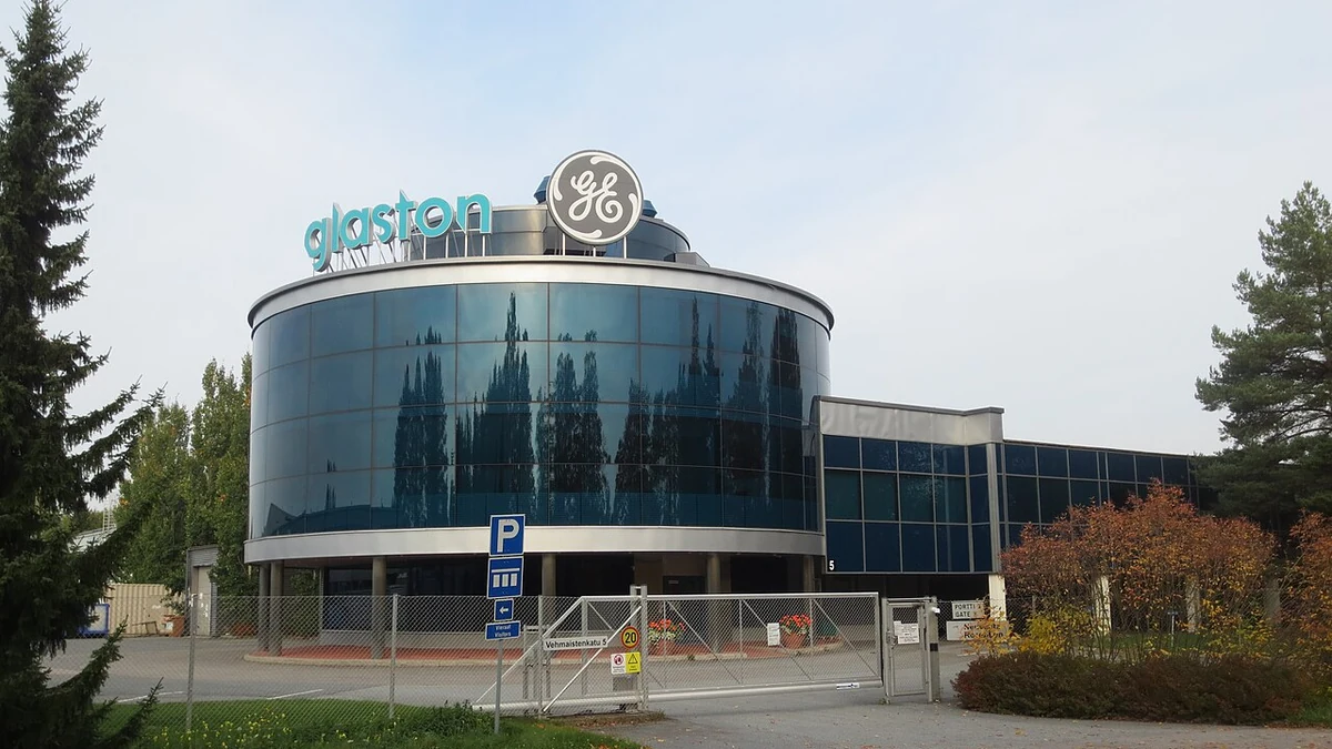 Glass-fronted GE Grid Solutions facility in Tampere, Finland, with GE and Alstom signage.