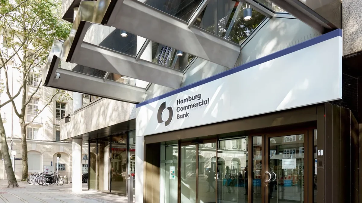 Entrance to Hamburg Commercial Bank in Hamburg, Germany, with its name and logo displayed above the doors.