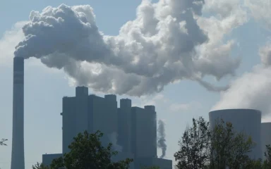 Factory chimneys and cooling towers with smoke in Germany.