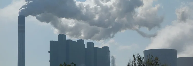 Factory chimneys and cooling towers with smoke in Germany.