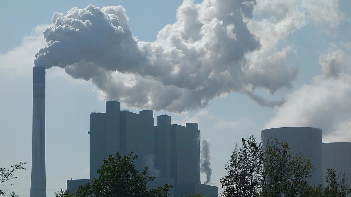 Factory chimneys and cooling towers with smoke in Germany.