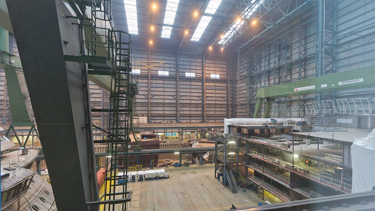Interior of the Meyer Werft shipyard in Papenburg, Germany, with shipbuilding structures and industrial equipment.