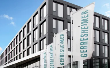 Gerresheimer AG headquarters in Düsseldorf with Gerresheimer flags outside.