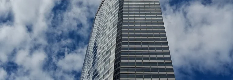 Goldman Sachs headquarters at 200 West Street in New York, photographed from street level against a cloudy sky.