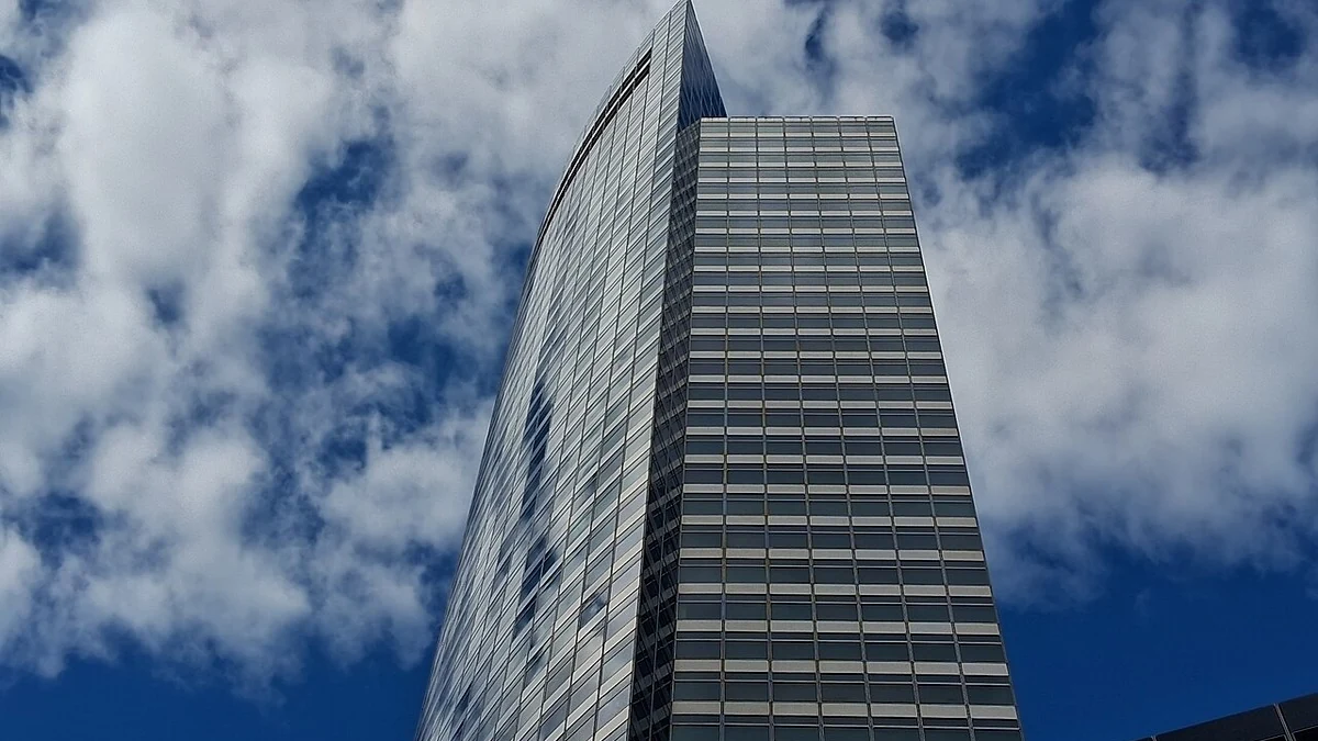 Goldman Sachs headquarters at 200 West Street in New York, photographed from street level against a cloudy sky.