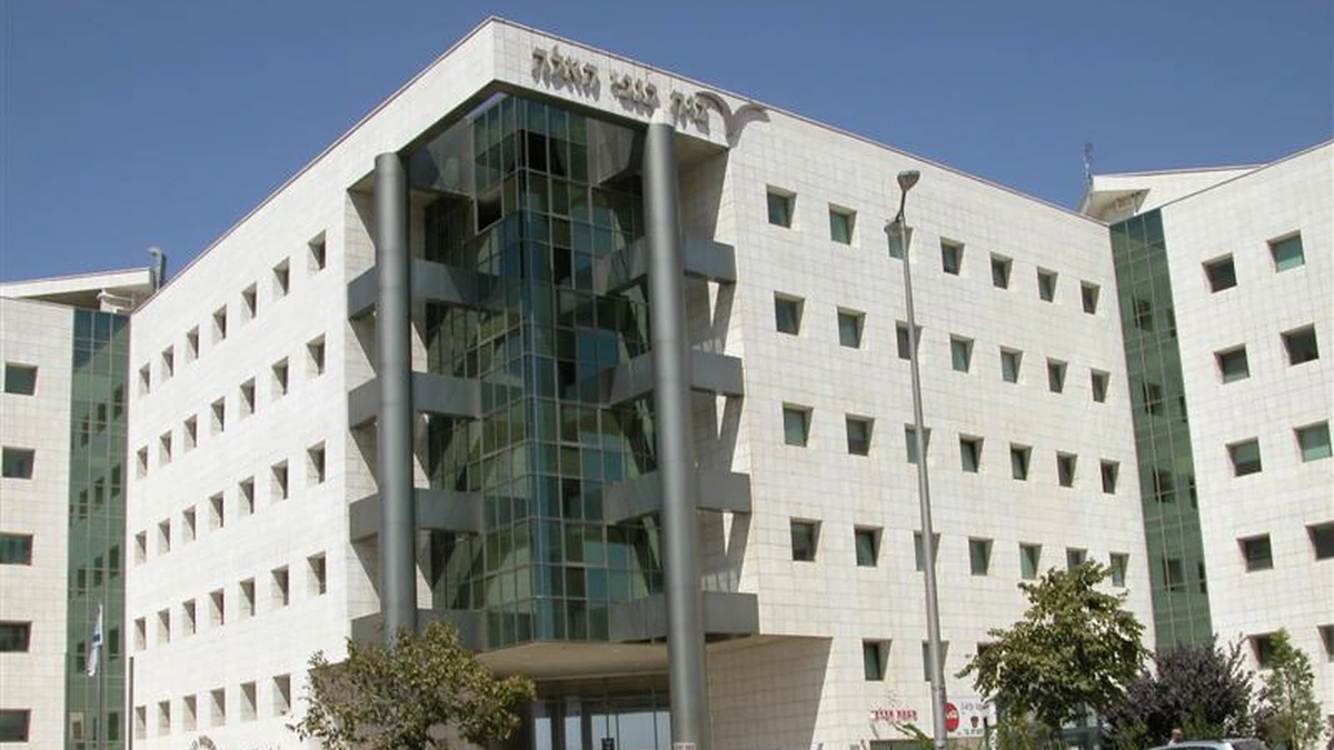 Exterior of the Israel Central Bureau of Statistics building in Jerusalem, with a glass-fronted entrance and Hebrew signage.
