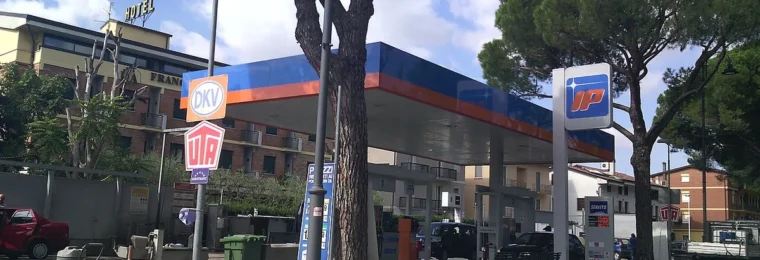 IP petrol station with fuel pumps and signs in Assisi, Italy.