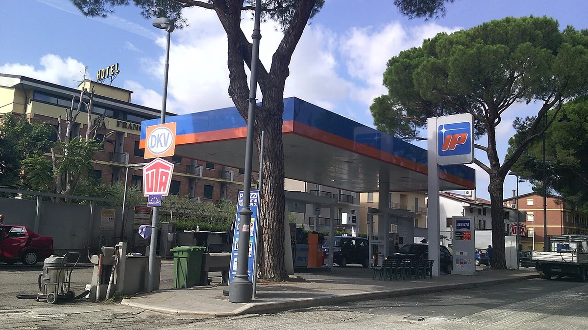 IP petrol station with fuel pumps and signs in Assisi, Italy.