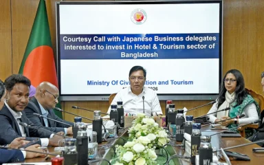 Japanese business representatives meet Bangladesh’s Civil Aviation and Tourism Minister M. Rashiduzzaman Millat at a conference table in Dhaka.