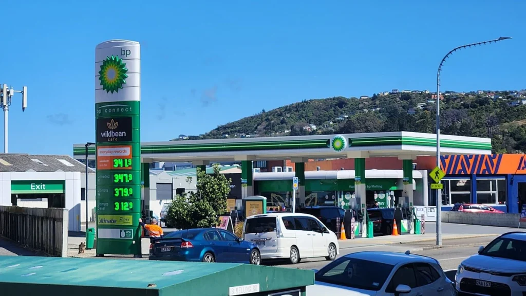 A BP petrol station, fuel price sign and parked cars on Melling Road in Lower Hutt, New Zealand.