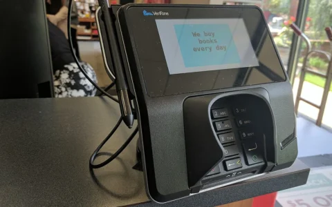 Verifone touchscreen card-payment terminal at the checkout of a U.S. university bookstore.