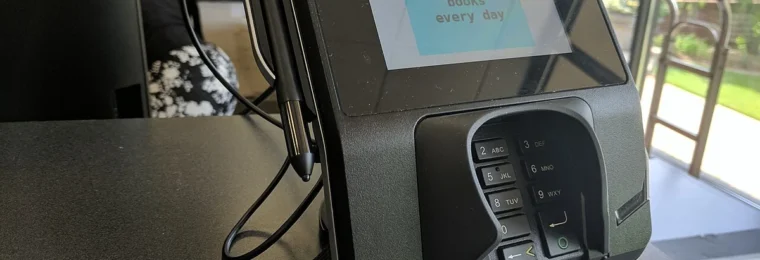 Verifone touchscreen card-payment terminal at the checkout of a U.S. university bookstore.