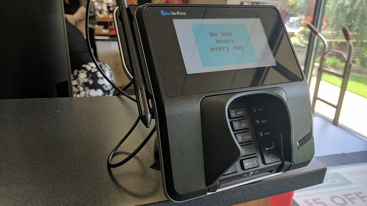 Verifone touchscreen card-payment terminal at the checkout of a U.S. university bookstore.