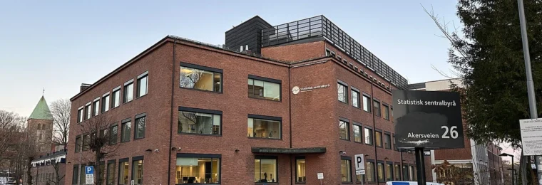 Statistics Norway office building at Akersveien 26 in Oslo, with agency signage and a parking area.