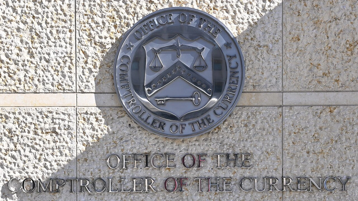 Office of the Comptroller of the Currency seal and lettering on the wall outside its Washington, D.C., headquarters.