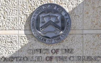 Office of the Comptroller of the Currency wall seal and signage in Washington, D.C.