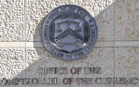 Office of the Comptroller of the Currency wall seal and signage in Washington, D.C.