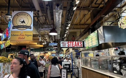 Customers and food vendors inside Reading Terminal Market in Philadelphia, Pennsylvania.