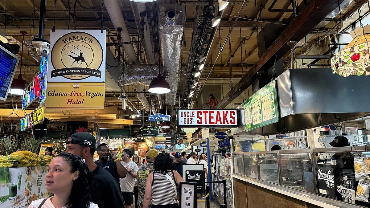 Customers and food vendors inside Reading Terminal Market in Philadelphia, Pennsylvania.