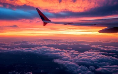 Aircraft wing above clouds at sunset, representing PHINIA's aerospace business.