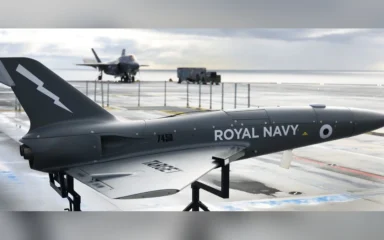 A QinetiQ Banshee target drone on the flight deck of the Royal Navy aircraft carrier HMS Prince of Wales during a 2021 trial.