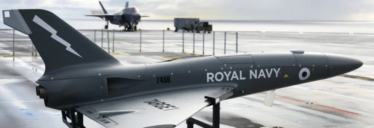 A QinetiQ Banshee target drone on the flight deck of the Royal Navy aircraft carrier HMS Prince of Wales during a 2021 trial.