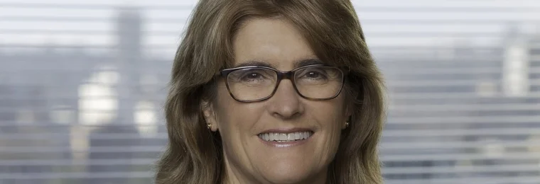 Portrait of Reserve Bank of Australia Governor Michele Bullock wearing glasses and a dark jacket.