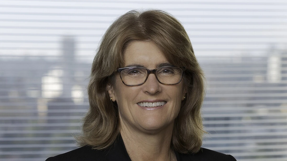 Portrait of Reserve Bank of Australia Governor Michele Bullock wearing glasses and a dark jacket.