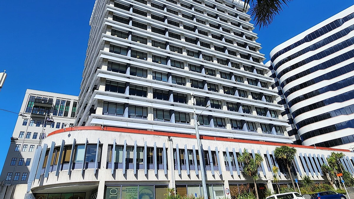 Street-level view of the Reserve Bank of New Zealand building and entrance signage in Wellington.