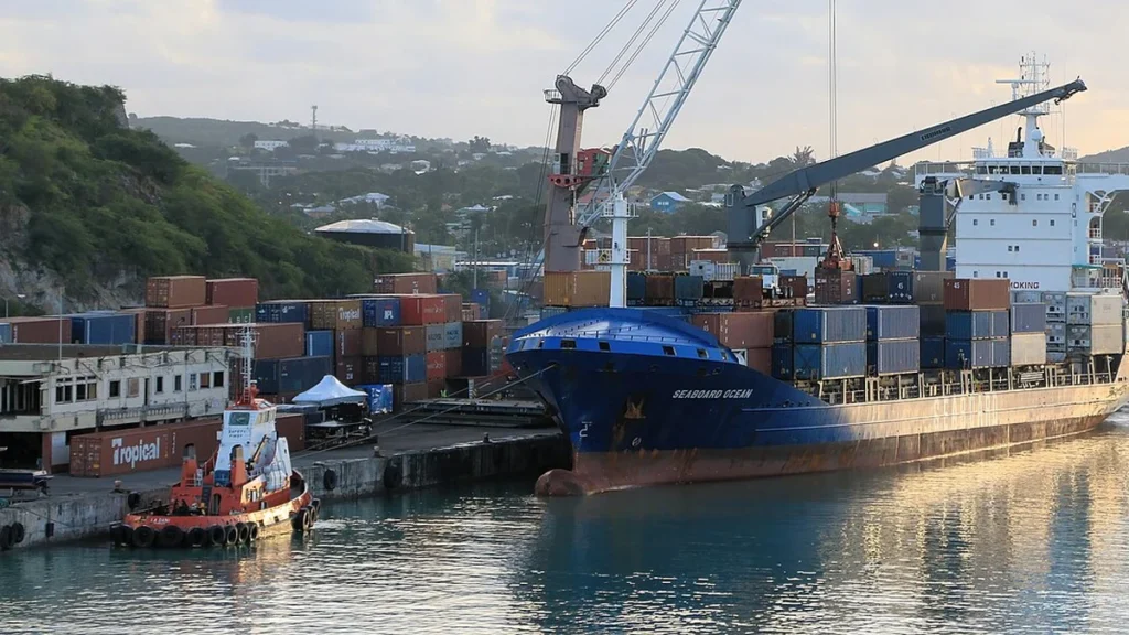 Seaboard Ocean container vessel docked in Antigua beside stacked shipping containers.