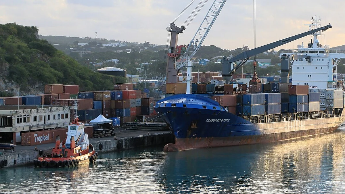 Seaboard Ocean container vessel docked in Antigua beside stacked shipping containers.