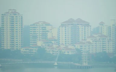 Haze obscures high-rise residential buildings and a waterfront in Tanjong Rhu, Singapore, on September 14, 2026.