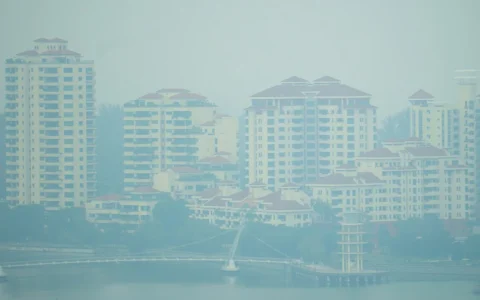 Haze obscures high-rise residential buildings and a waterfront in Tanjong Rhu, Singapore, on September 14, 2026.