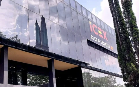 Glass facade of the ICEX and COFIDES offices in Madrid, with ICEX COFIDES signage visible.