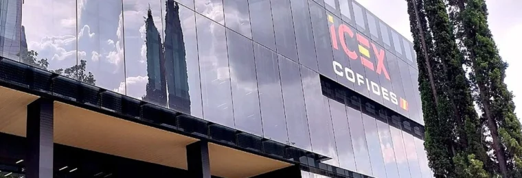 Glass facade of the ICEX and COFIDES offices in Madrid, with ICEX COFIDES signage visible.