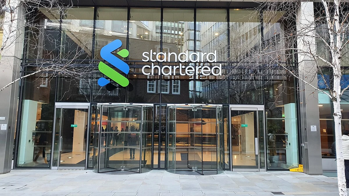 Standard Chartered headquarters entrance in London with the bank's logo above the doors.