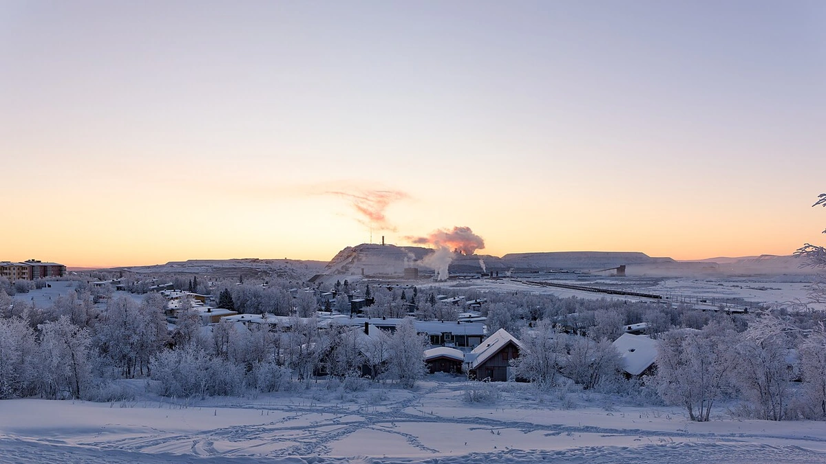 Snow-covered view of the Kiruna iron ore mine in Sweden at sunrise.