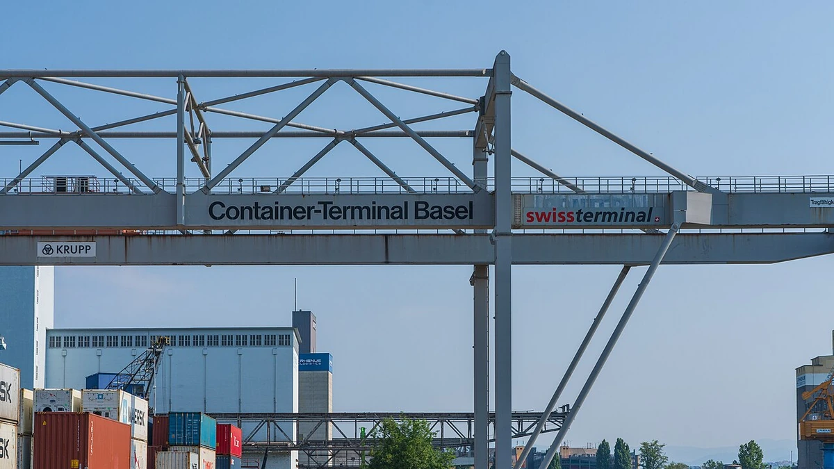 Container gantry crane above stacked freight containers at the Kleinhüningen Rhine port in Basel, Switzerland.