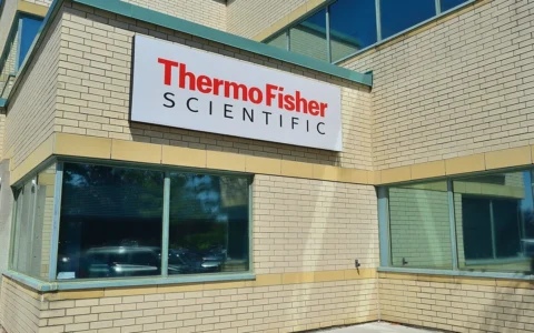 Thermo Fisher Scientific sign on a brick office building in Markham, Ontario.