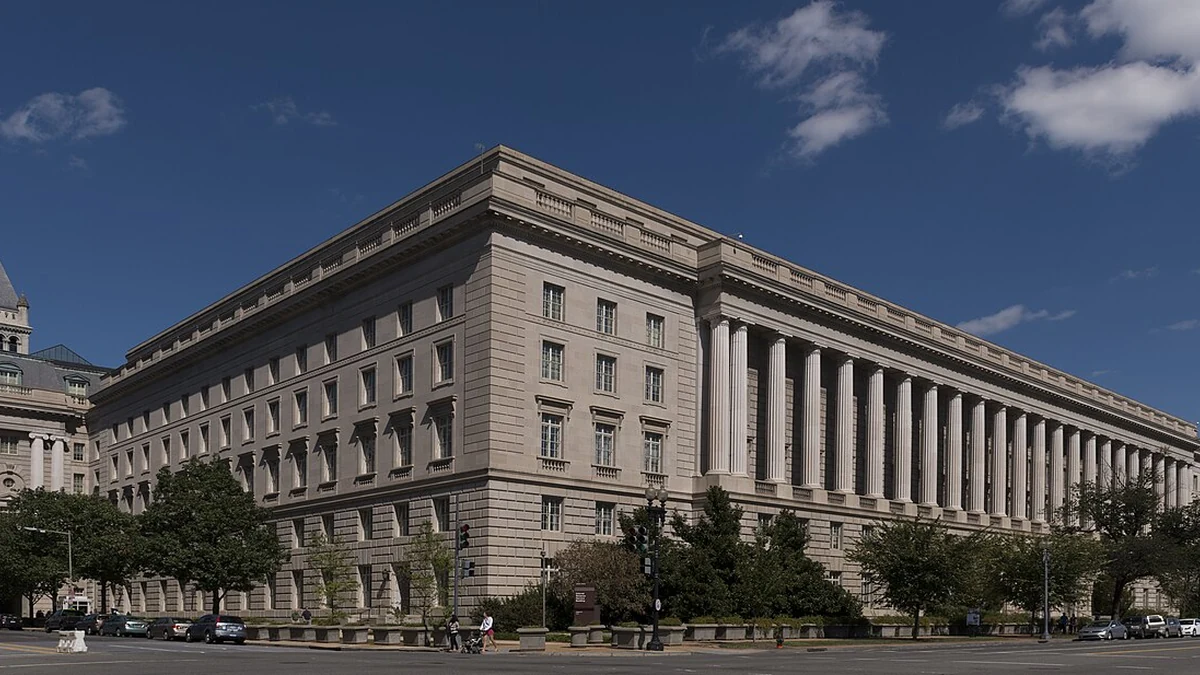 Facade of the Internal Revenue Service building in the Federal Triangle area of Washington, D.C., beneath a blue sky.