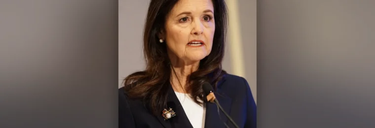 Judy Shelton speaking at a microphone during the 2026 ASSA Annual Meeting in Philadelphia.