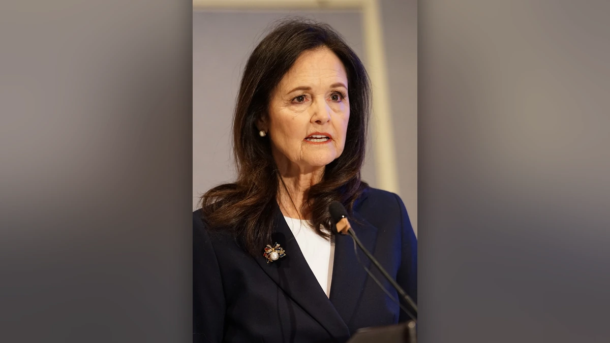 Judy Shelton speaking at a microphone during the 2026 ASSA Annual Meeting in Philadelphia.